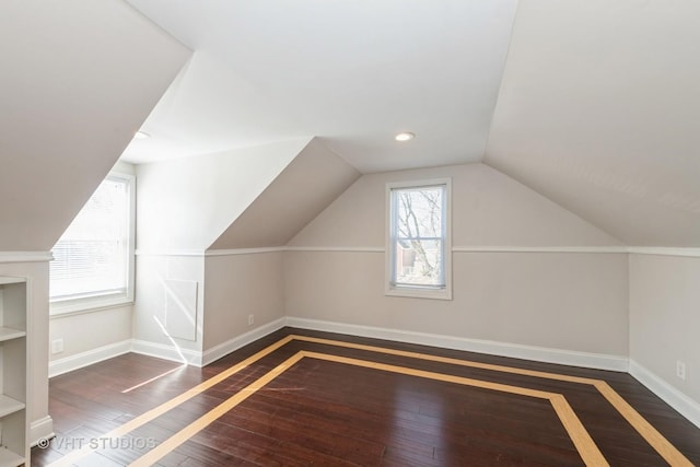 bonus room with lofted ceiling, baseboards, hardwood / wood-style floors, and recessed lighting