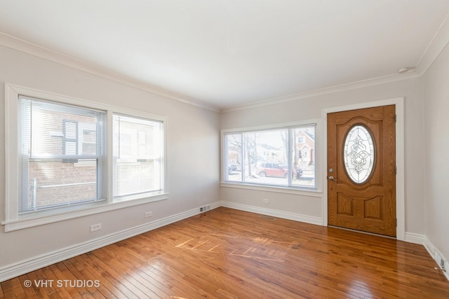 entrance foyer with baseboards, plenty of natural light, visible vents, and light wood-style floors