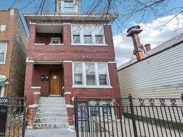 view of front of house with a fenced front yard and brick siding