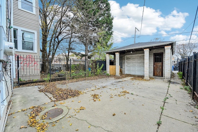 detached garage with driveway and fence