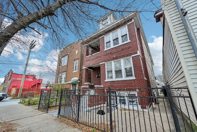 view of front of house with a fenced front yard and brick siding