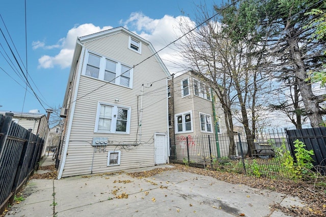 rear view of house featuring a patio area and a fenced backyard