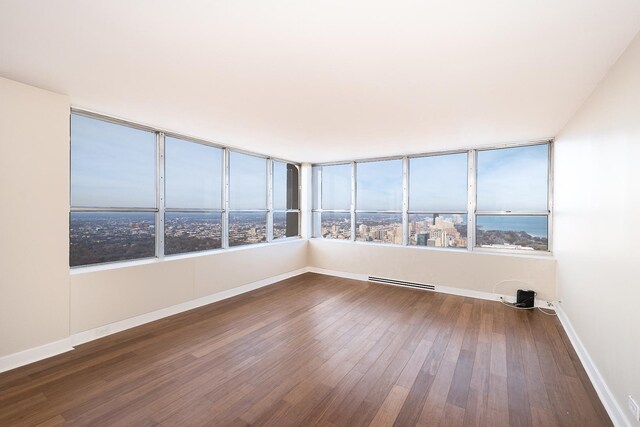 unfurnished sunroom with baseboard heating