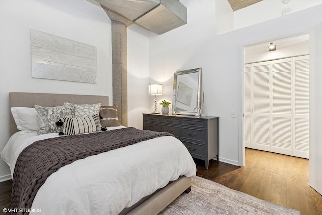 bedroom featuring baseboards and wood finished floors