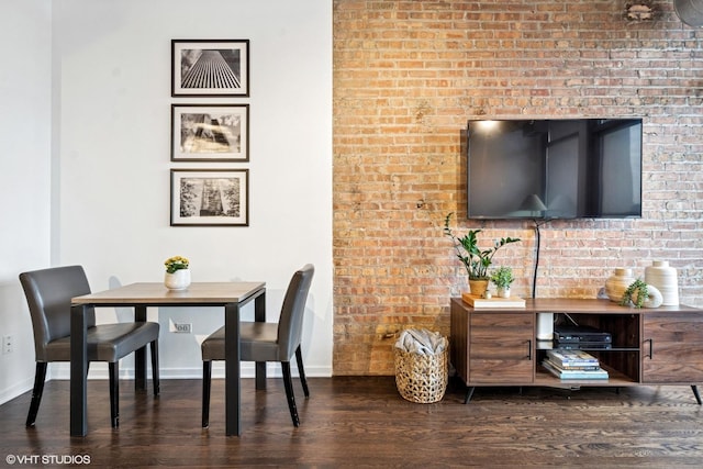 dining space with baseboards and wood finished floors