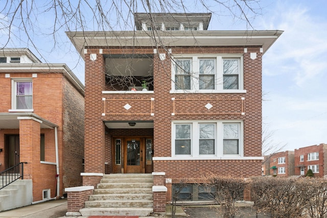 view of front facade featuring entry steps and brick siding