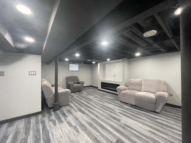 living area featuring baseboards and wood finished floors