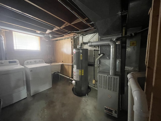 below grade area with water heater, a sink, and washer and dryer