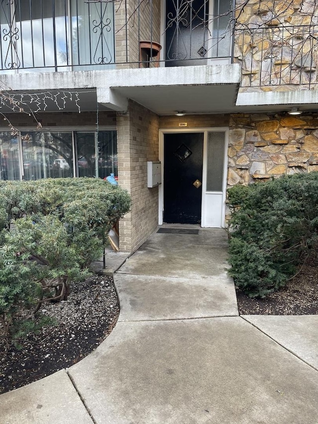 view of exterior entry with brick siding