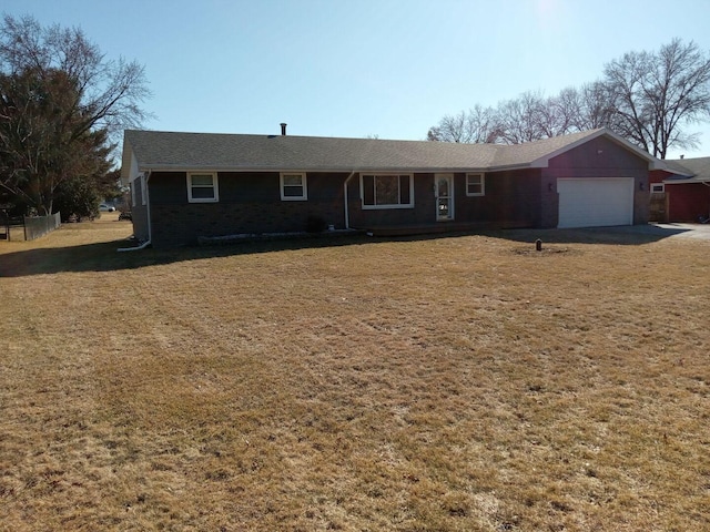 ranch-style home featuring a front lawn and an attached garage