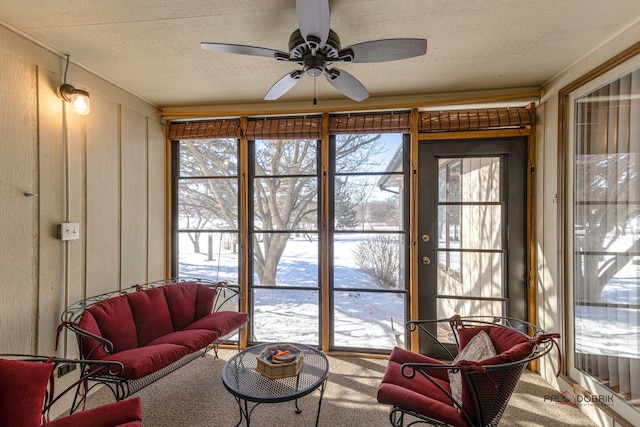 sunroom / solarium featuring ceiling fan