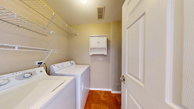 washroom featuring laundry area, baseboards, and separate washer and dryer