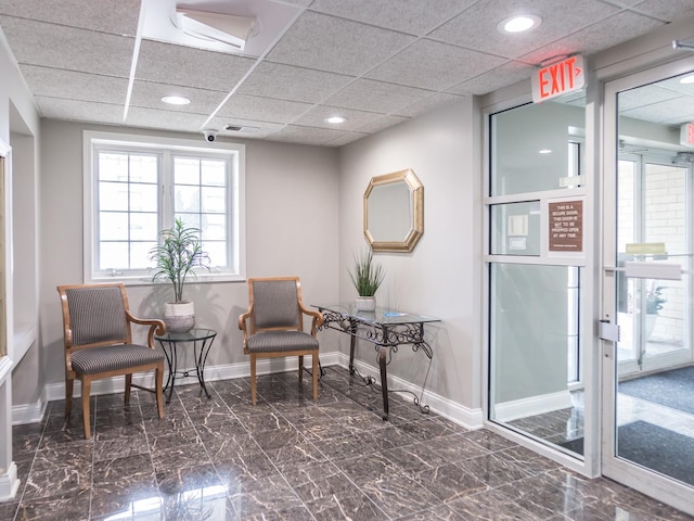 living area with recessed lighting, marble finish floor, and baseboards