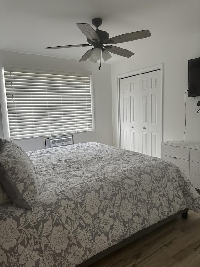 bedroom with ceiling fan, a closet, and dark wood finished floors