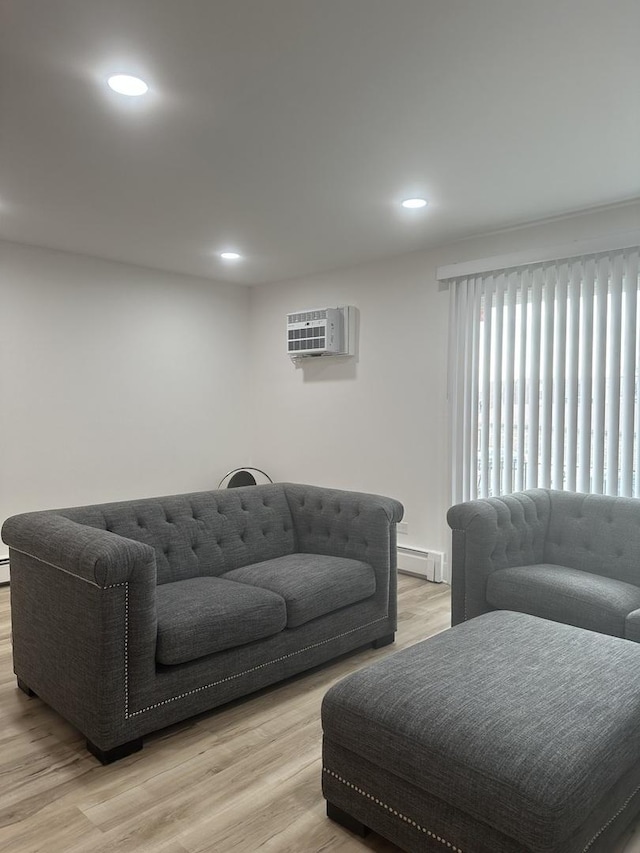 living room featuring recessed lighting, light wood-style flooring, and a wall mounted AC