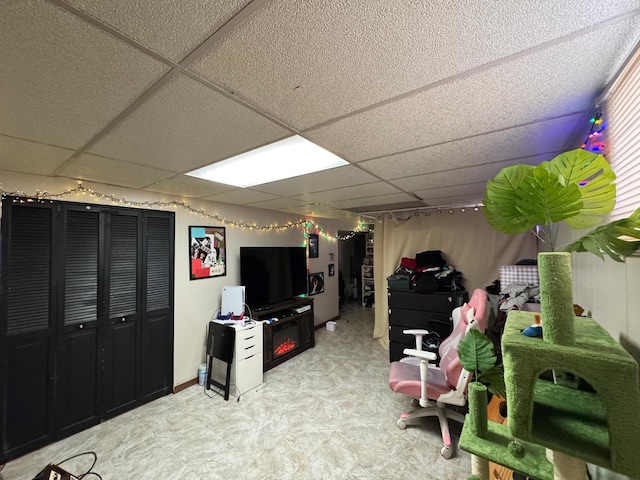 recreation room with a paneled ceiling