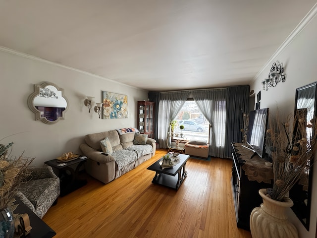 living area with ornamental molding and wood finished floors