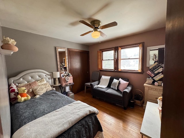 bedroom with ceiling fan, a closet, and wood finished floors