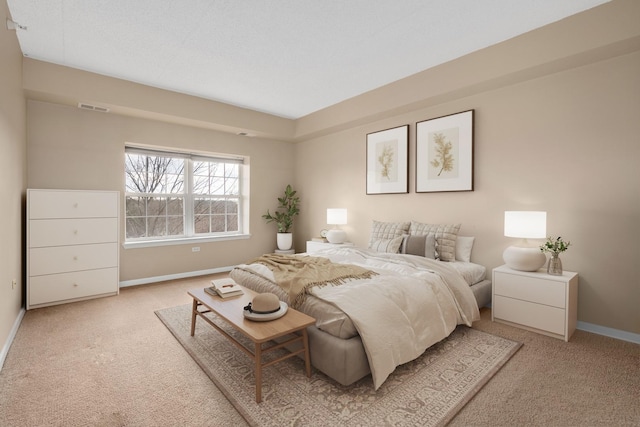 bedroom featuring light carpet, baseboards, and visible vents