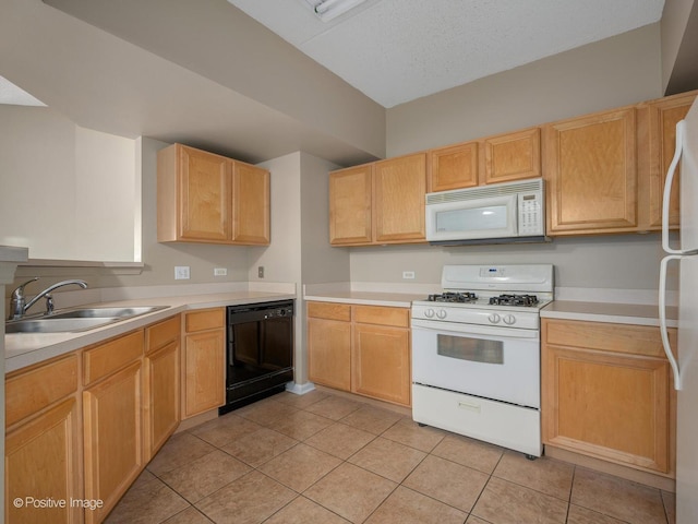 kitchen featuring light tile patterned floors, a textured ceiling, white appliances, a sink, and light countertops