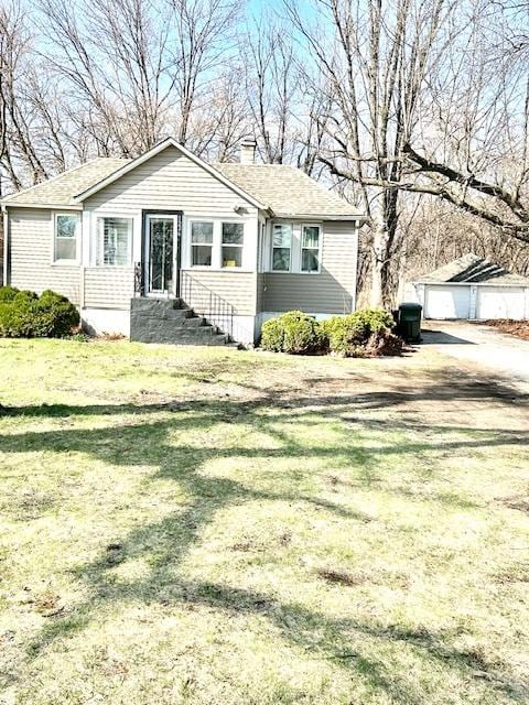1226 175th St, East Hazel Crest, IL 60429 - view of front facade featuring an outbuilding, a front lawn, and a chimney