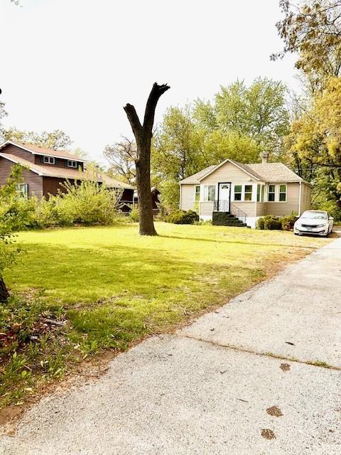 1226 175th St, East Hazel Crest, IL 60429 - view of front of home with a front lawn