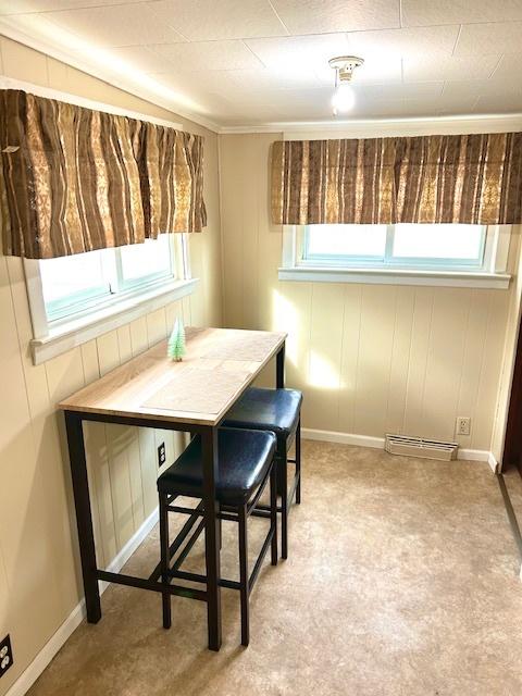 dining space with breakfast area, a healthy amount of sunlight, and baseboards