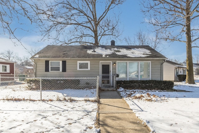 view of front of home with a fenced front yard and a chimney