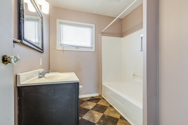 full bathroom featuring toilet, shower / bath combination, baseboards, and vanity