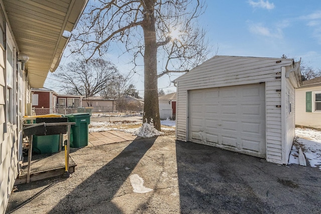 view of yard with an outbuilding, fence, and driveway