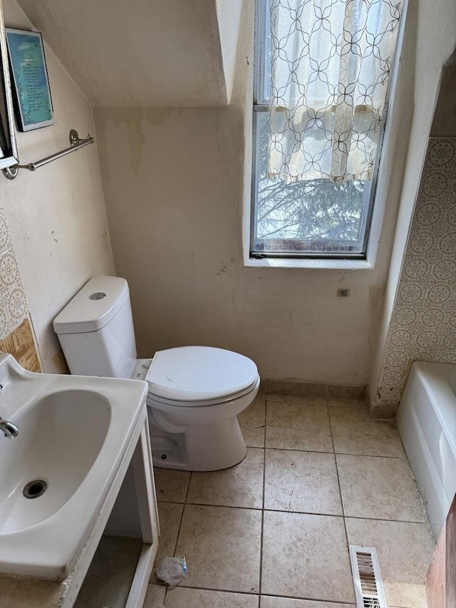 bathroom featuring tile patterned flooring, visible vents, a sink, and toilet