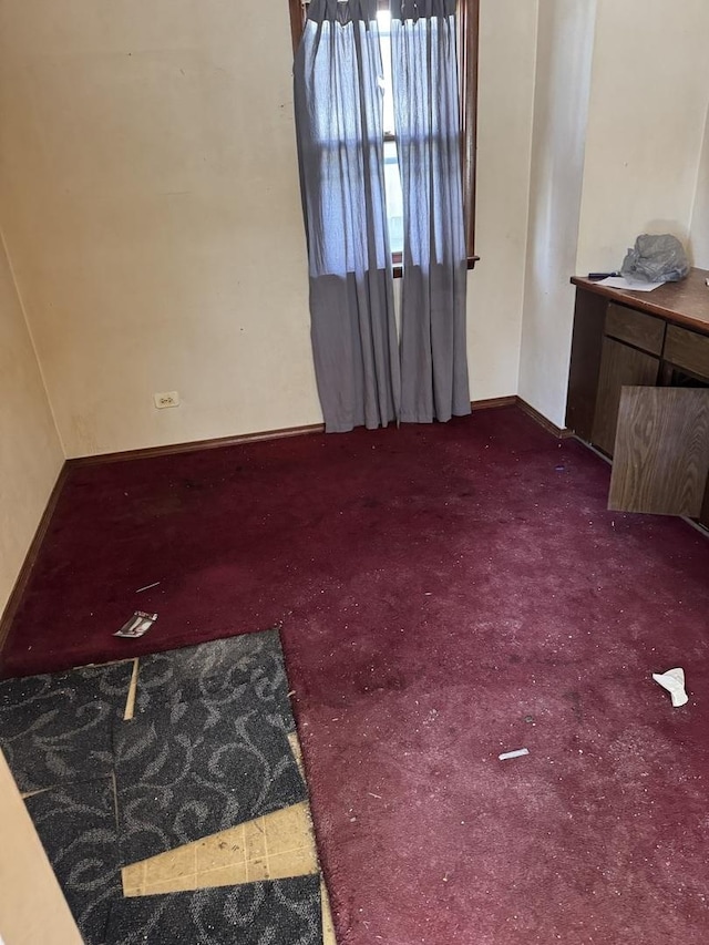 empty room featuring dark colored carpet