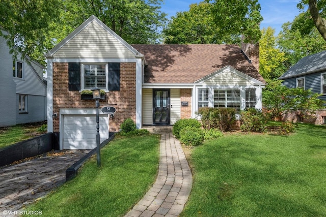 view of front facade with a garage, brick siding, a chimney, and aphalt driveway