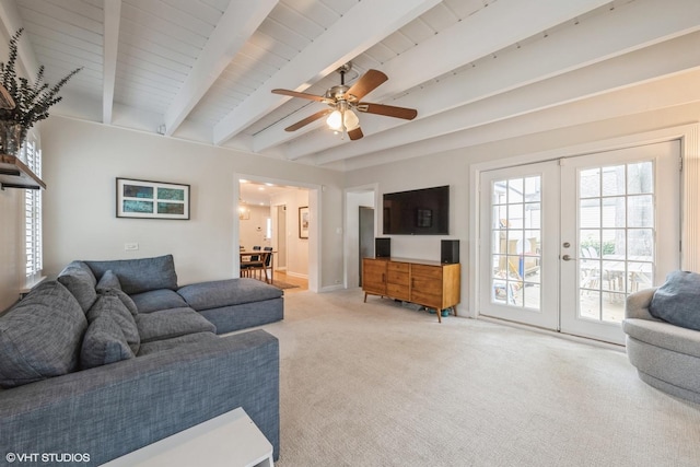 living area featuring light carpet, french doors, beam ceiling, and a ceiling fan