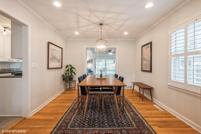 dining room with baseboards, light wood-style floors, recessed lighting, and crown molding