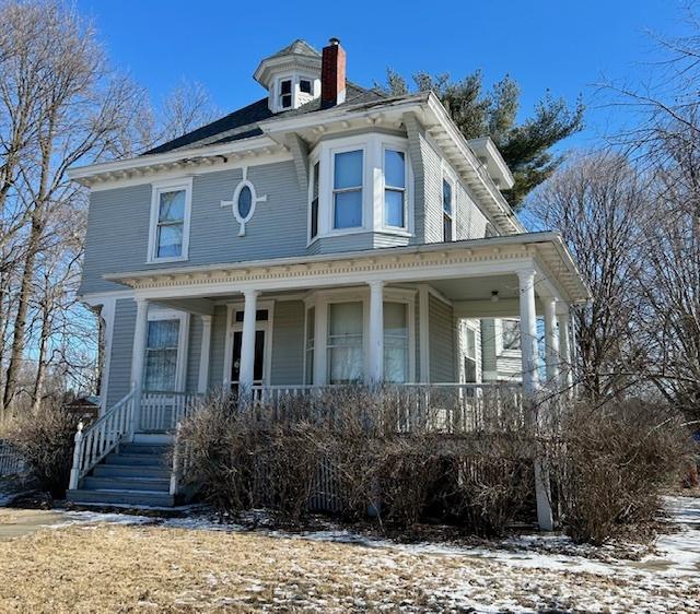 view of front of house with a porch and a chimney