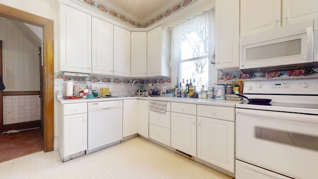 kitchen with light countertops, white appliances, white cabinetry, and wallpapered walls