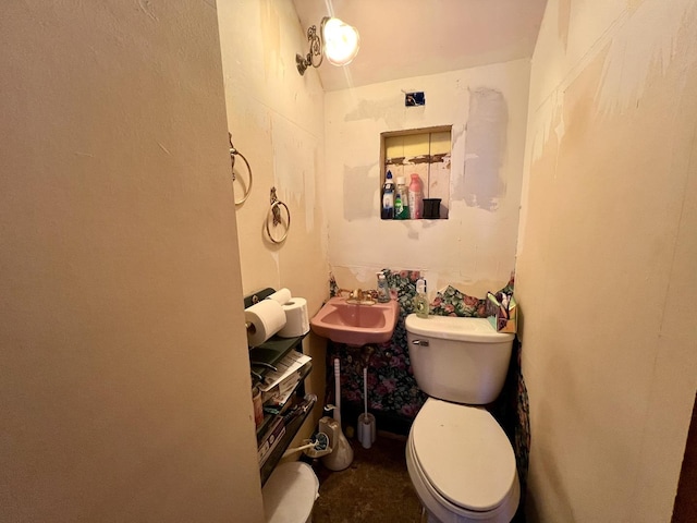 half bathroom with a sink and toilet