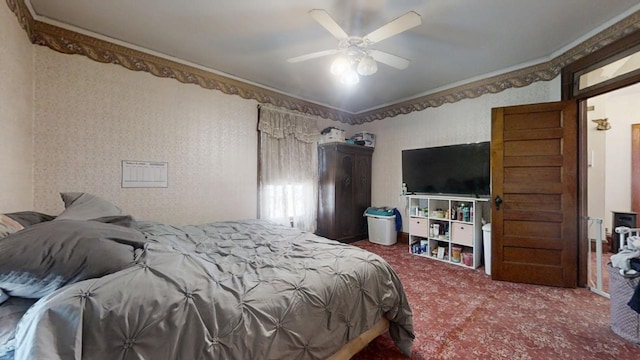 bedroom featuring ceiling fan, carpet floors, ornamental molding, and wallpapered walls