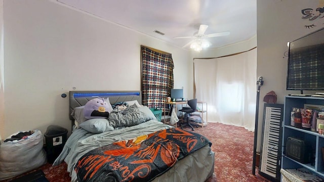 carpeted bedroom with visible vents and ceiling fan