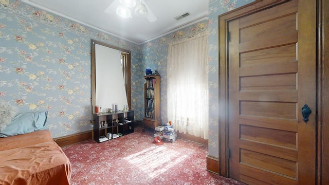 spare room with visible vents, ornamental molding, ceiling fan, baseboards, and wallpapered walls