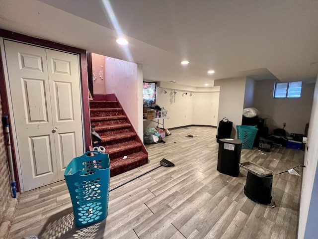 exercise room featuring baseboards, wood finished floors, and recessed lighting