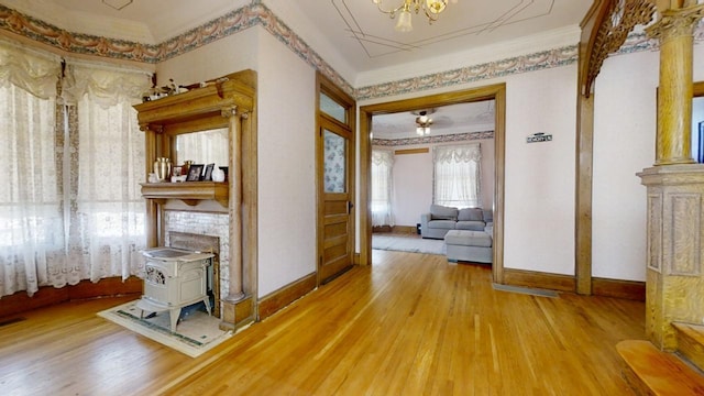 hall with light wood finished floors, baseboards, and crown molding