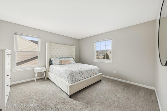 carpeted bedroom featuring baseboards