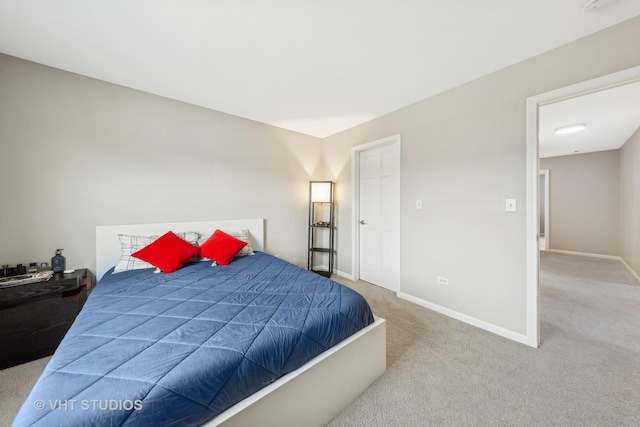 bedroom featuring baseboards and light colored carpet