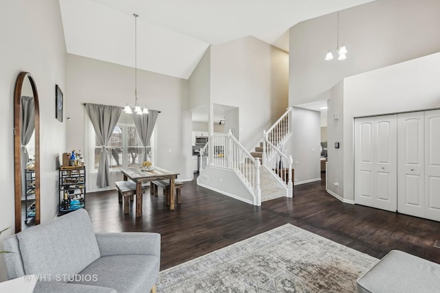 entryway featuring dark wood-style flooring, stairway, and a notable chandelier