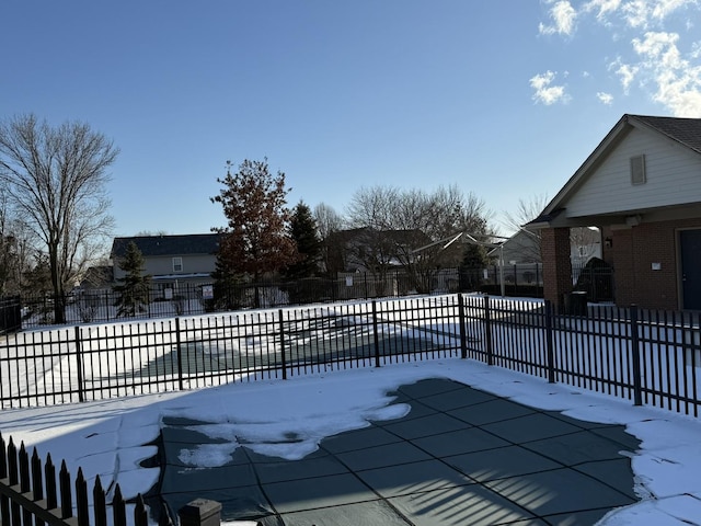 snow covered pool with fence and a community pool