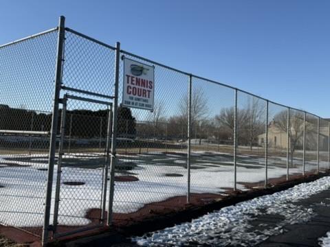 view of sport court with fence and a gate