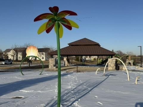 snow covered playground with a gazebo