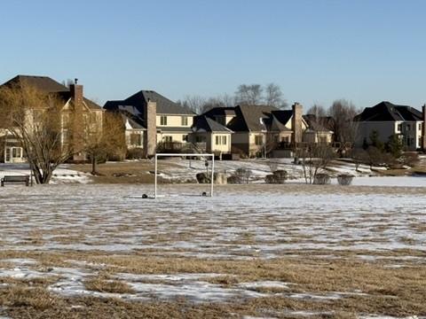 snowy yard with a residential view